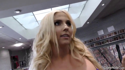 Twee zwarte pikken voor een rondborstig blondje in de Glory Hole